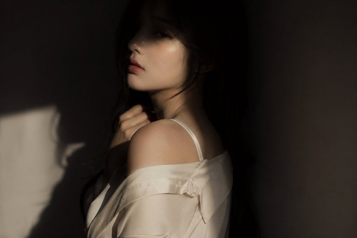 editorial portrait, Korean female idol, subtly sensual outfit: silk shirt or soft fabric...