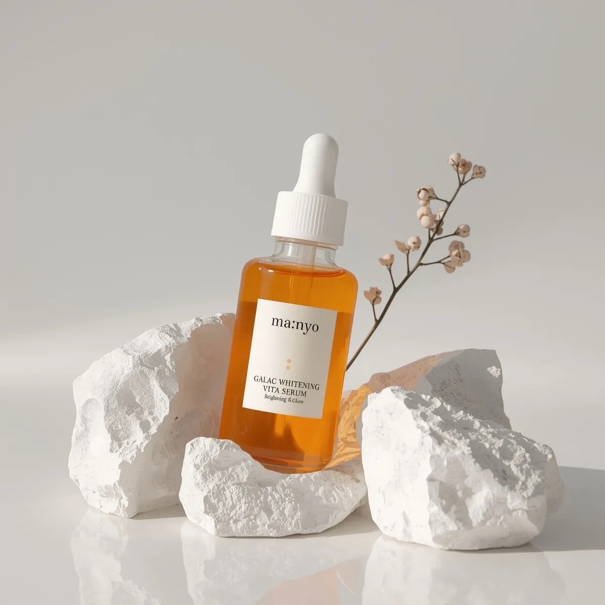 Minimalist studio product photography of an amber glass dropper serum bottle with white c...