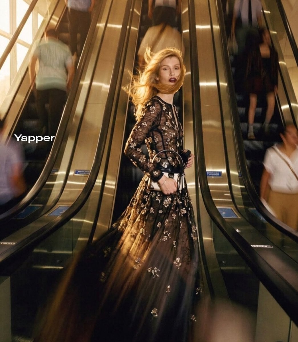 Ultra-realistic cinematic fashion photograph of a stylish blonde woman standing confident...